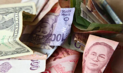 high angle shot pile banknotes from different countries wooden surface1