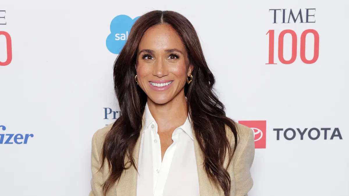 Serial Netflix Terbaru Meghan Markle kembali berkarier, Meghan Markle tersenyum di depan latar belakang acara Time 100