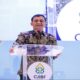 Fantastis! Potensi Investasi Jawa Tengah Tembus Rp19,07 Triliun di CJIBF 2026 74 Gubernur Jawa Tengah Nana Sudjana berpidato di balik podium dengan logo CJIBF di acara Central Java Investment Business Forum