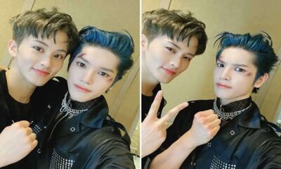 Mark dan Taeyong NCT berpose bersama mengenakan pakaian serba hitam dengan riasan luka di wajah