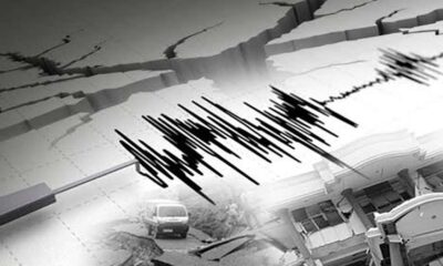 Ilustrasi grafik gempa bumi dengan latar belakang retakan tanah dan bangunan rusak