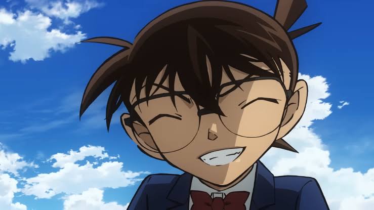 Aoyama Gosho Bocorkan 1 Rahasia Penting Akhir Cerita Detective Conan 52 Ilustrasi Conan Edogawa tersenyum gembira dengan latar belakang langit biru dan awan