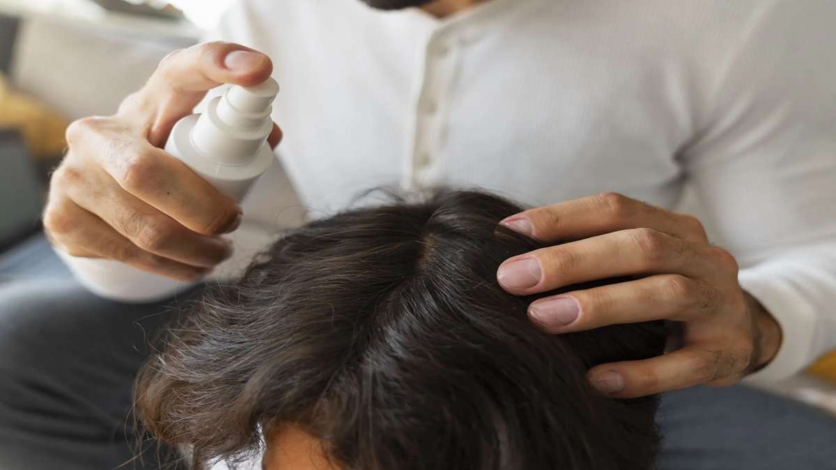 7 Rahasia Ampuh Cara Menata Rambut Agar Tidak Lepek dan Bau Setelah Olahraga 53 Seseorang mengaplikasikan tonik rambut semprot ke kulit kepalanya
